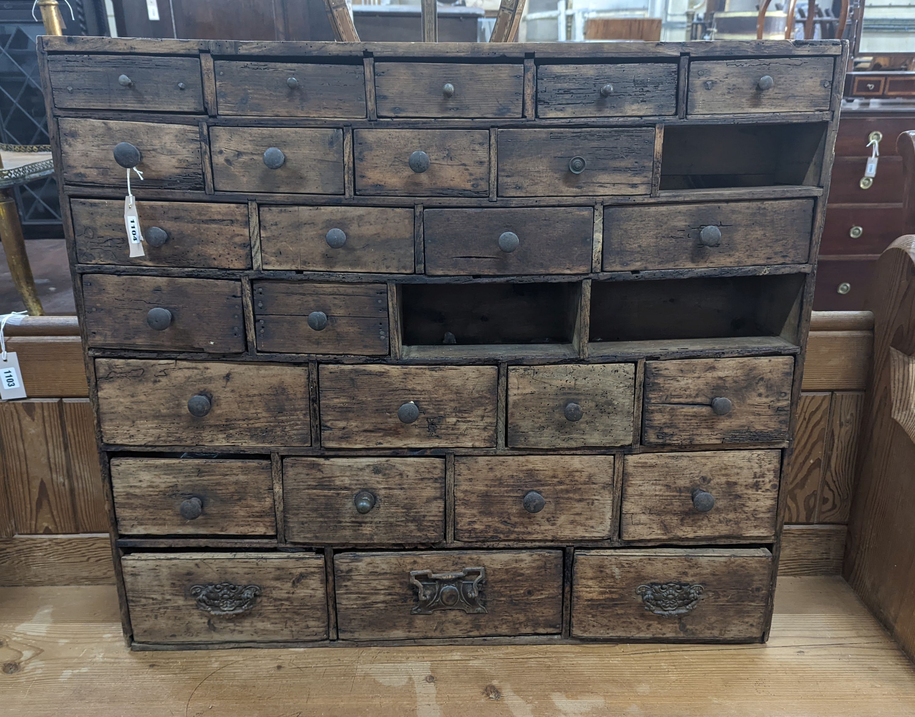 A 19th century fruitwood apothecary chest from the estate of Mary Wondrausch, containing rock samples and archaeological finds. width 91cm, depth 13cm, height 80cm (lacks three drawers)